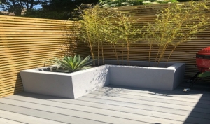 Composite decking, rendered beds and horizontal slatted fencing, East London