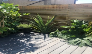 Horizontal fencing with grey composite decking, East London