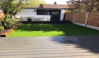 Dark composite decking, new lawn, raised beds and fencing, East London Dark composite decking, new lawn, raised beds and fencing, East London